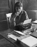 Sitting at a desk with a typewriter